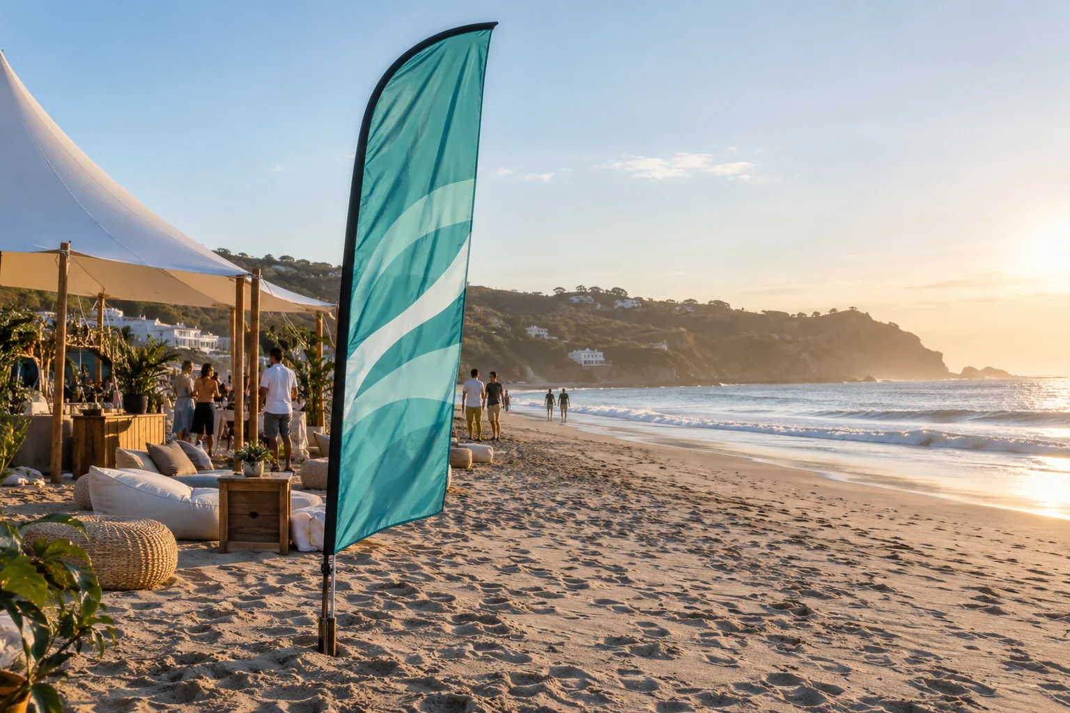 Sea-green advertising flag beside a quiet beachfront event area