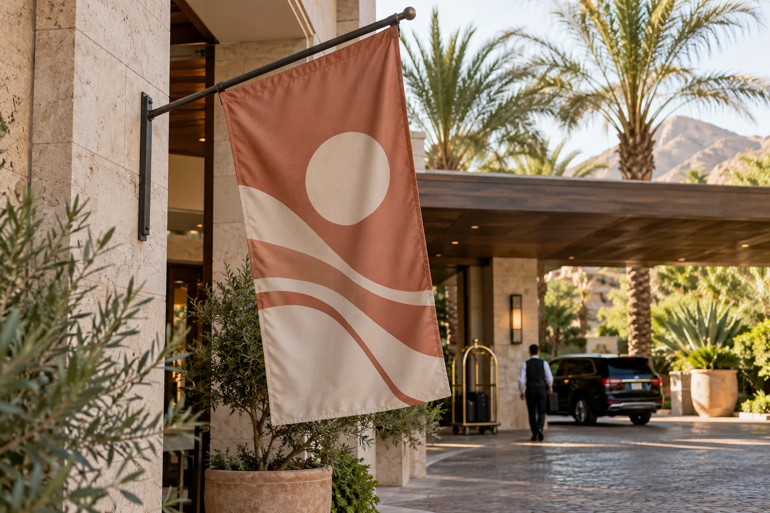 Terracotta hotel brand flag beside a palm-lined resort entrance