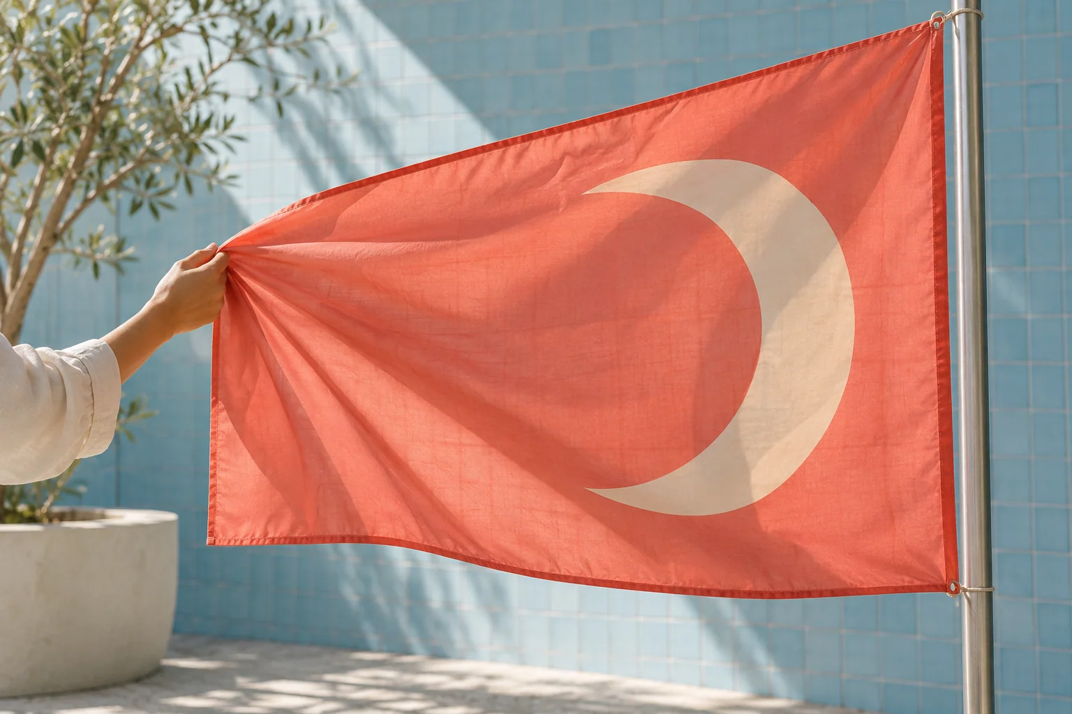 Coral flag with an asymmetric cream emblem seen from the reverse